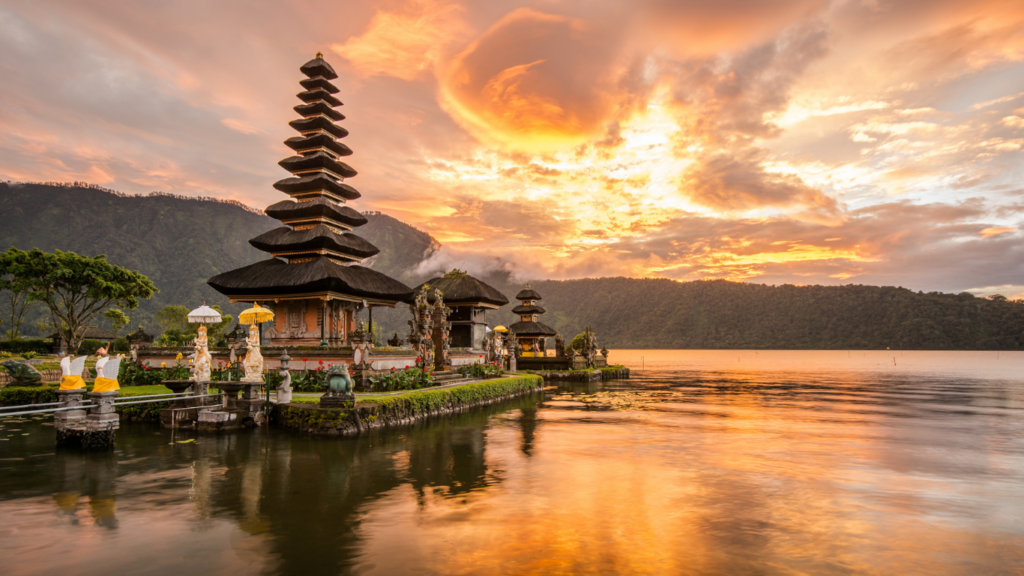 Scenic view of Ulun Danu Beratan temple on a lake in Bali at sunset, illustrating why the island attracts foreigners buy property in Bali and foreigners buy villa in Bali .