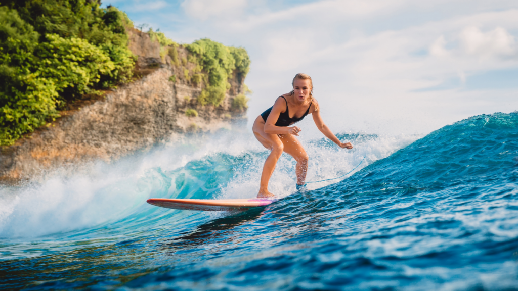 Surfer riding waves in Canggu, best places to stay in Canggu Bali for surf, cafes, and long-term living