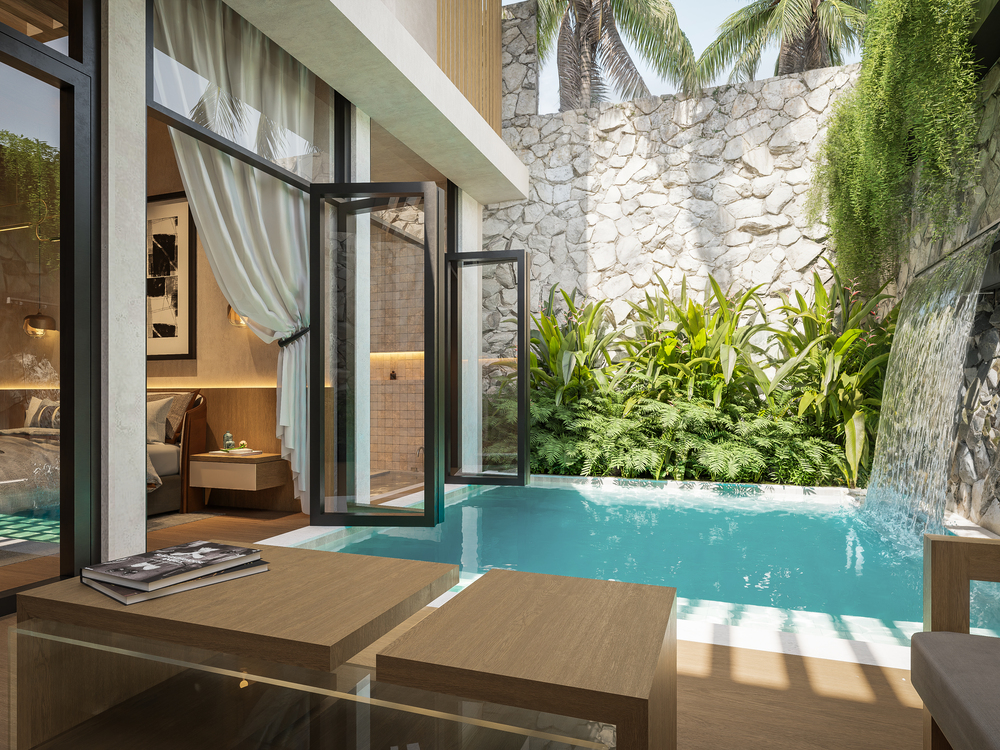 Private courtyard pool with open glass doors connecting to a villa bedroom and lounge, showing indoor outdoor design that supports overseas property investment and renting in Bali.